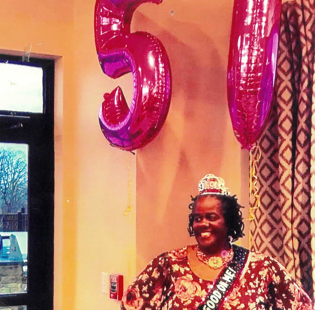 Shari with a crown, sash, and balloons on her 50th birthday in Massachusetts.