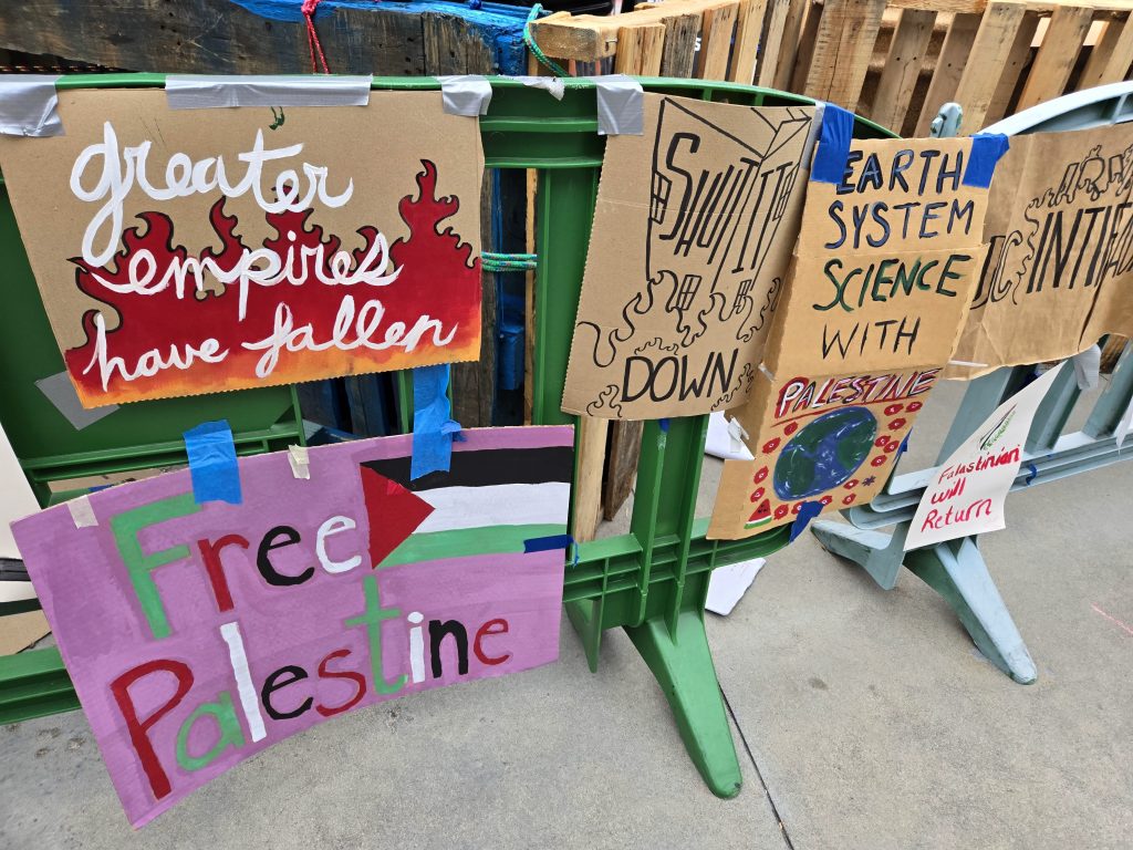 Barricades adorned with political posters surrounded the student encampment. 